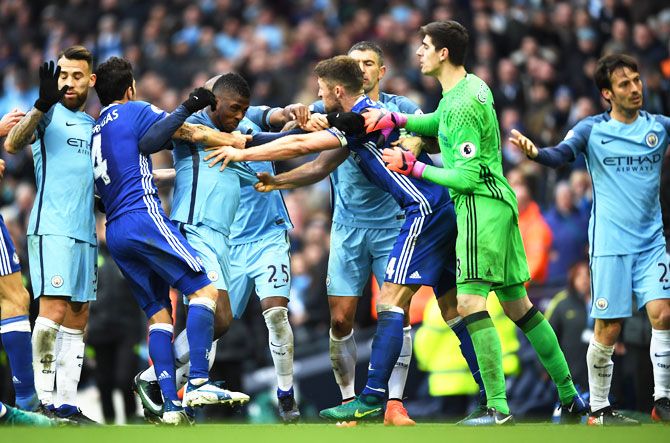 Chelsea's Gary Cahill and Manchester City's Kelechi Iheanacho get into a scuffle while other players try to separate them