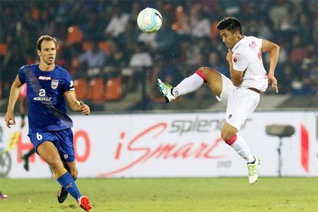 Delhi Dynamos'Malsawmzuala shoots the ball away from Mumbai City FC's Kristian Vadocz during their ISL match in Mumbai on Saturday