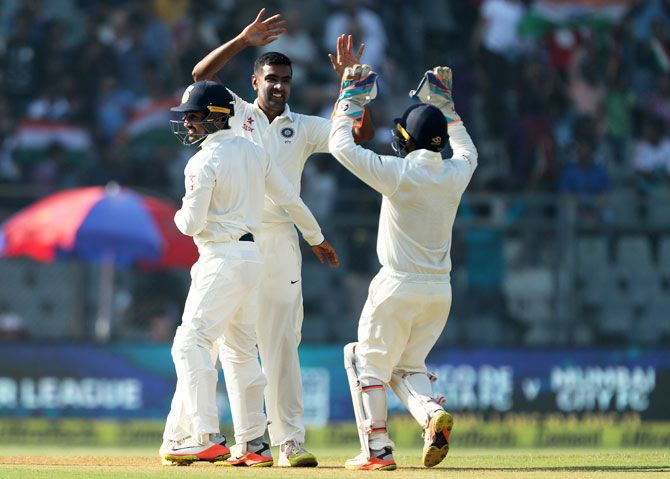 India's Ravichandran Ashwin celebrates the wicket of England's Adil Rashid during Day 5 of the fourth Test match at the Wankhede Stadium in Mumbai on Monday