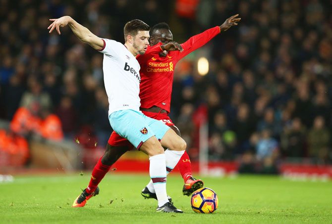 West Ham United's Aaron Cresswell and Liverpool's Sadio Mane vie for the ball