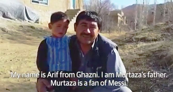 A video grab of Murtaza Ahmadi with his father 