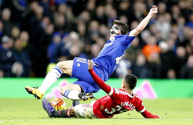 Manchester Unted's Jesse Lingard fouls Chelsea's Cesar Azpilicueta