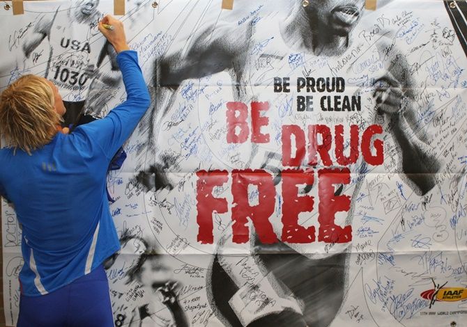 Athlete signs a campaign poster during an Anti-doping Agency workshop