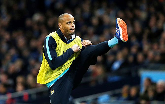 Manchester City's Vincent Kompany warms up on the sidelines