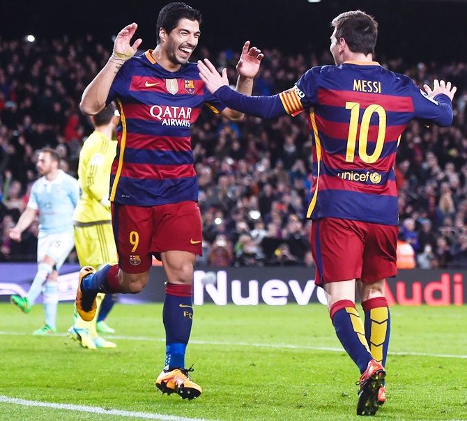 Barcelona's Luis Suarez, left, celebrates with his team mate Lionel Messi