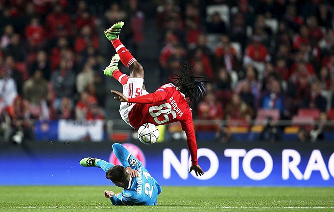 Benfica's Renato Sanches (top) falls over as he vies for an aerial ball against Zenit St. Petersburg's Javi Garcia