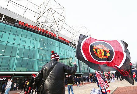 A Manchester United supporter waves the flag