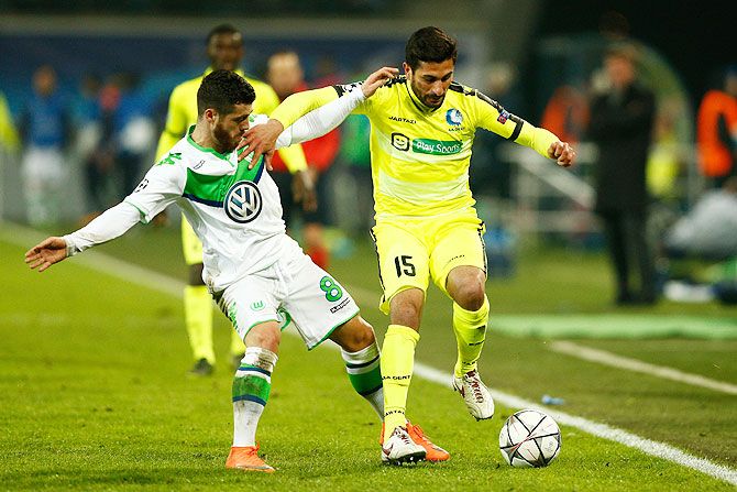 Gent's Kenny Saief is challenged by Wolfsburg's Vierinha