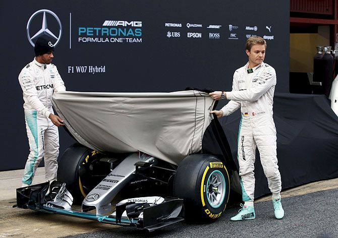 Mercedes Formula One drivers Lewis Hamilton of Britain (left) and Nico Rosberg of Germany unveil the new Mercedes F1 W07 hybrid car before the first testing session ahead of the upcoming season at the Circuit Catalunya-Barcelona in Montmelo, Spain, on Monday