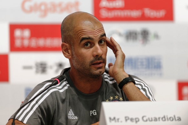 Pep Guardiola looks on during the a press conference 