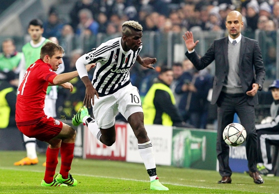 Paul Pogba (right) of Juventus competes for the ball with Philipp Lahm of FC Bayern Muenchen 