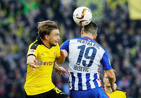 Borussia Dortmund's Marcel Schmelzer and Hertha Berlin's Vedad Ibisevic in an aeriel duel