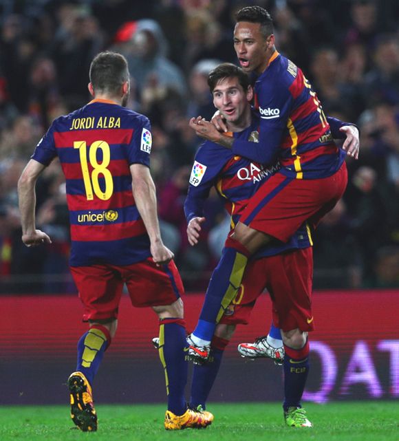 Lionel Messi celebrates with teammates Neymar and Jordi Alba after scoring the opening goal