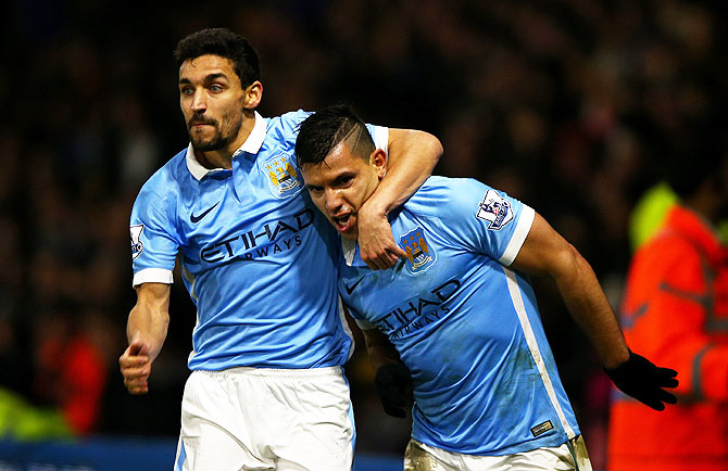 Manchester City'S Sergio Aguero (right) celebrates with teammate Jesus Navas after scoring his side's second goal against Watford at Vicarage Road in Watford