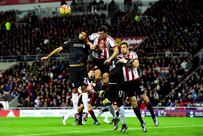 Liverpool's Emre Can and Mamadou Sakho involved in an aeriel challenge against Sunderland's Billy Jones and Sebastian Coates during their Barclays English Premier League match at Stadium of Light in Sunderland on December 30, 2015