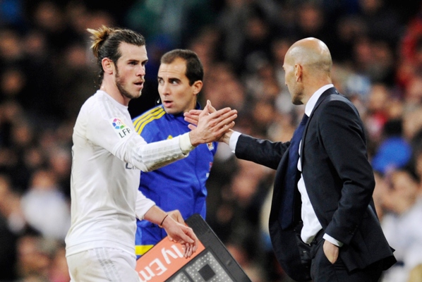 Hat-trick scorer Gareth Bale of Real Madrid shakes hands with manager Zinedine Zidane 