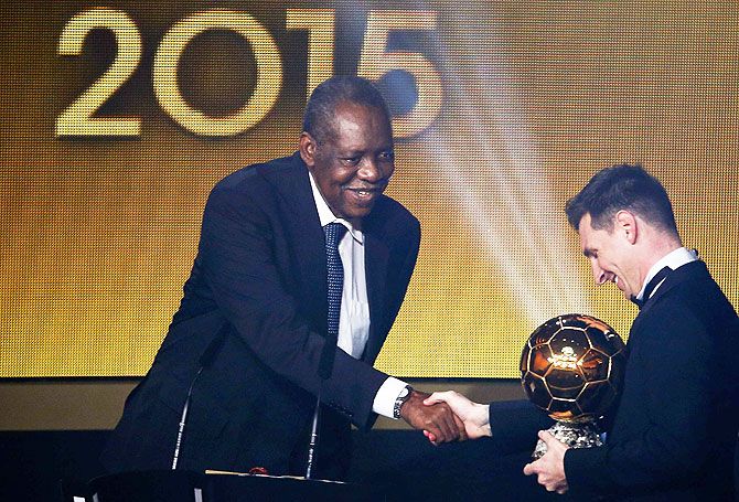 FIFA acting president Issa Hayatou (left) congratulates FC Barcelona's and Argentina's Lionel Messi on winning the FIFA Ballon d'Or 2015 award for the world player of the year at a ceremony in Zurich on Monday