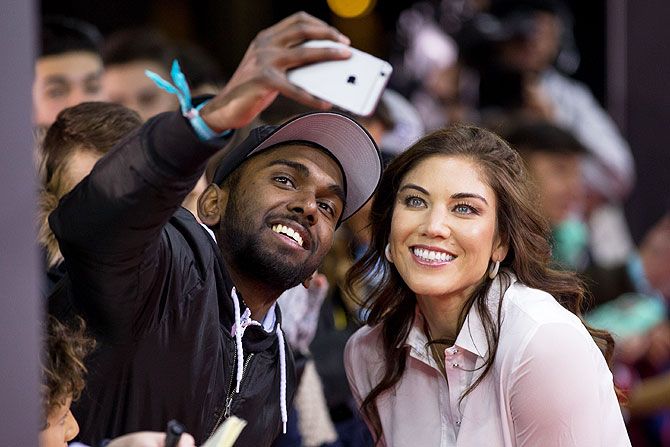 US women's footballer Hope Solo takes a selfie with a fan as she arrives for the FIFA Ballon d'Or Gala