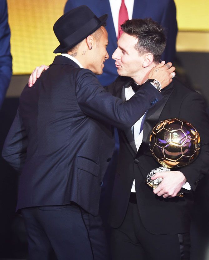 FC Barcelona's Lionel Messi is congratulated by teammate Neymar after winning of the Ballon d'or