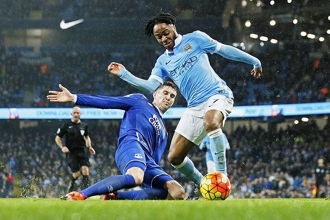 Everton's John Stones is challenged by Manchester City's Raheem Sterling during their match at the Etihad Stadium on Wednesday