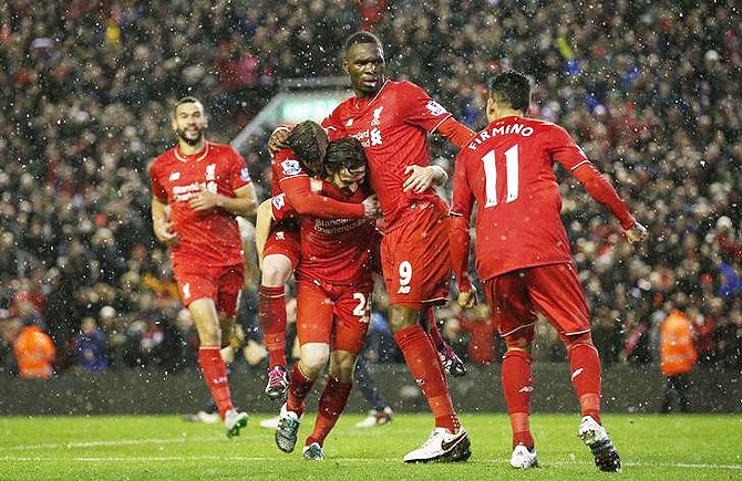 Liverpool's Joe Allen celebrates with teammates on scoring the third goal at Anfield on Wednesday