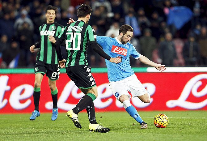 Napoli's Gonzalo Higuain shoots to score against Sassuolo during their Serie A match on Saturday