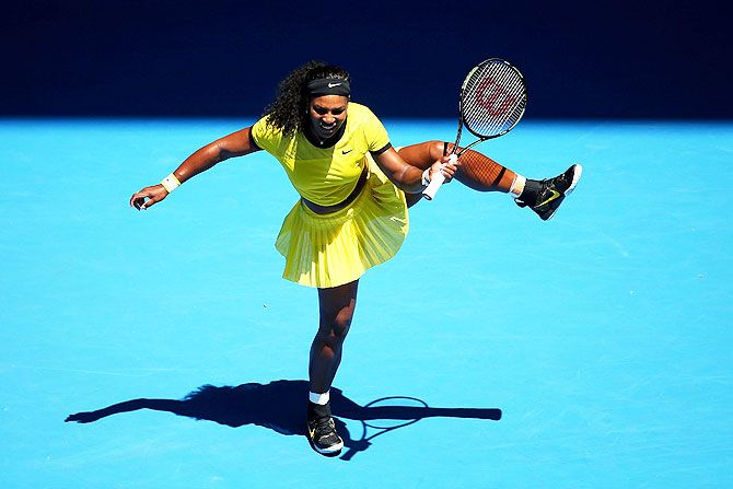 USA's Serena Williams plays a shot in her first round match against Italy's Camila Giorgi in their first round match of the 2016 Australian Open at Melbourne Park on Monday