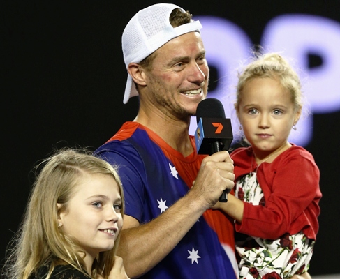 Lleyton Hewitt of Australia is interviewed on court with his children 