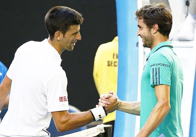 Novak Djokovic (left) and Gilles Simon shake hands at the net after their fourth round match on Sunday