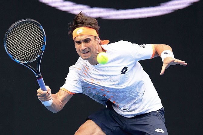 Spain's David Ferrer plays a forehand during his fourth round match against USA's John Isner