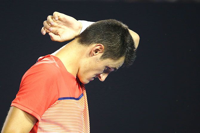 Bernard Tomic reacts during his fourth round match against Andy Murray