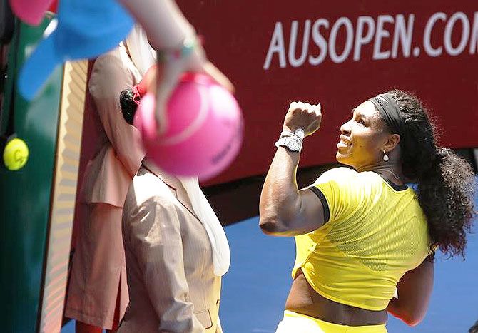 Serena Williams of the U.S. signs autographs after winning her quarter-final match against Russia's Maria Sharapova at the Australian Open tennis tournament at Melbourne Park on Tuesday