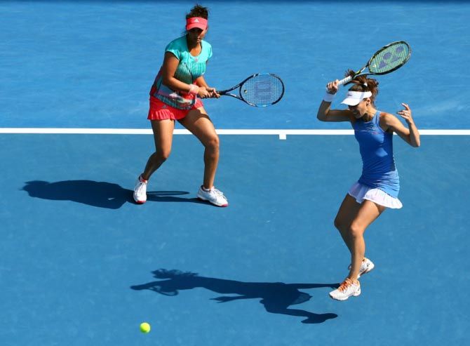 Sania Mirza (left) and Martina Hingis in action