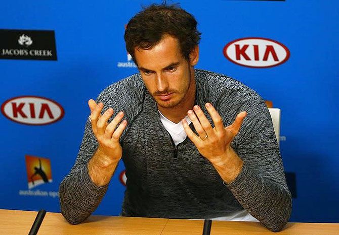 Andy Murray gestures during a news conference after losing his final against Novak Djokovic