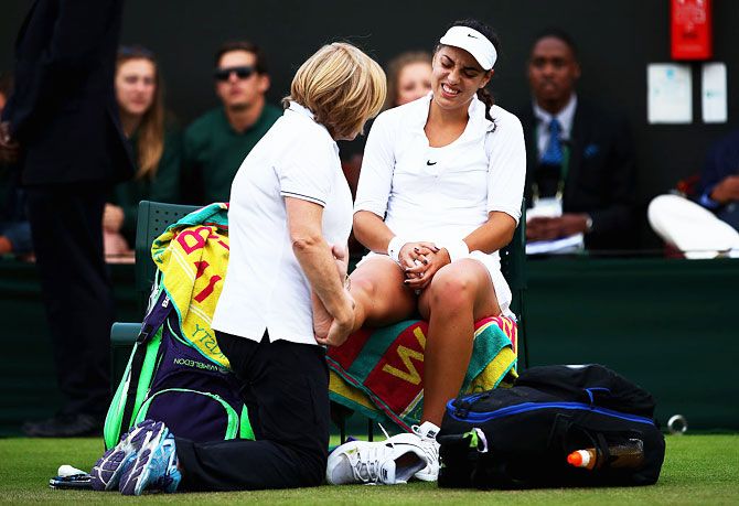 Croatia's Ana Konjuh receives treatment on her ankle during her second round match against Poland's Agnieszka Radawanska