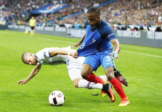France's Patrice Evra (right) is challenged by Iceland's Johann Gudmundsson