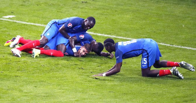 France players celebrate with Antoine Griezmann after scoring the fourth goal against Iceland during their Euro 2016 quarter-final match at Stade De France in Paris on Sunday