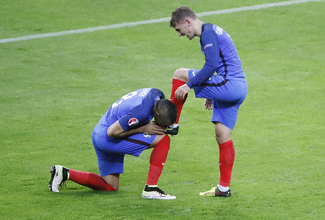 France's Dimitri Payet kisses the boot of Antoine Griezmann after the latter scored