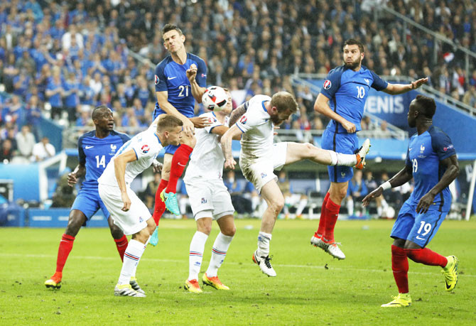 France's Laurent Koscielny and Andre-Pierre Gignac vie for an aerial ball with Iceland players
