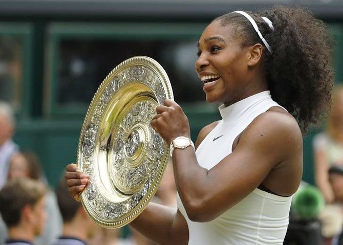USA's Serena Williams celebrates with the trophy on winning her Wimbledon women's singles final match against Germany's Angelique Kerber at the All England Lawn Tennis & Croquet Club, Wimbledon, in London on July 9 2016