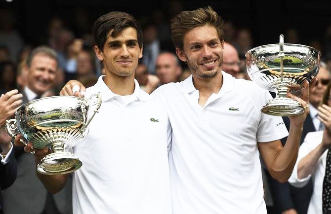 France's Pierre-Hugues Herbert and Nicolas Mahut celebrate winning their men's doubles final against compatriots Julien Benneteau and Edouard Roger-Vasselin at the All England Lawn Tennis & Croquet Club, Wimbledon, on Saturday