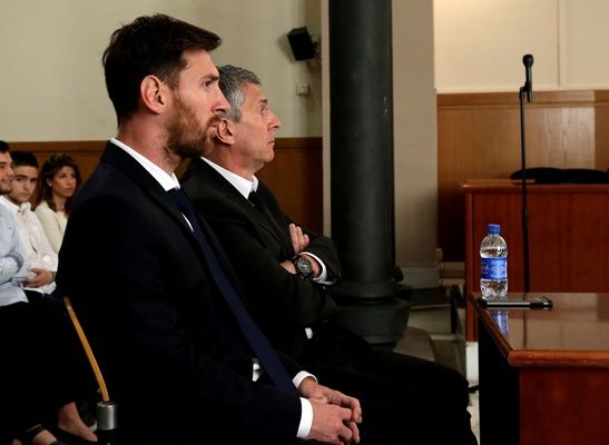 Lionel Messi (left) sits in court with his father Jorge Horacio Messi during their trial for tax fraud in Barcelona