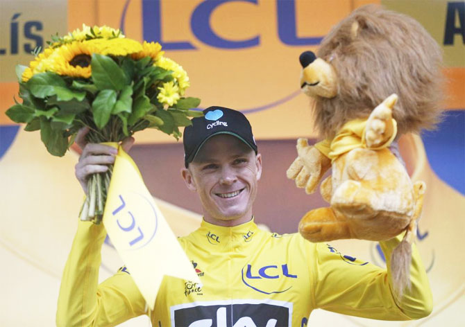 Yellow jersey leader Team Sky rider Chris Froome of Britain reacts on the podium