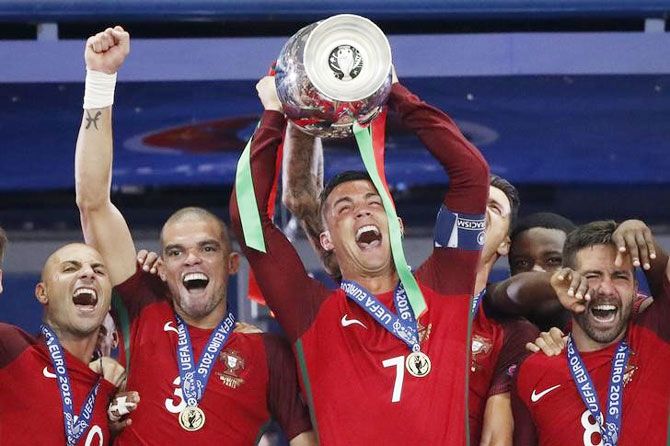 Portugal's Cristiano Ronaldo celebrates with Pepe, Ricardo Quaresma and Joao Moutinho and the trophy after winning Euro 2016 on Sunday