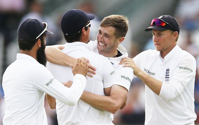 England's Chris Woakes (2nd from right) celebrates with captain Alastair Cook, and teammates Moeen Ali and Joe Root