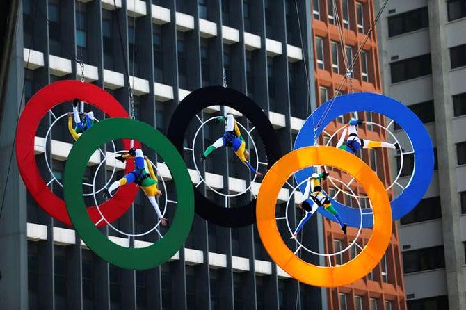 Acrobats perform on the Olympics rings at Paulista Avenue in Sao Paulo's financial center, Brazil, July 24, 2016