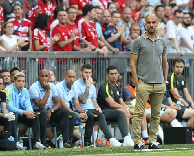 Manchester City boss Pep Guardiola watching over his new charges