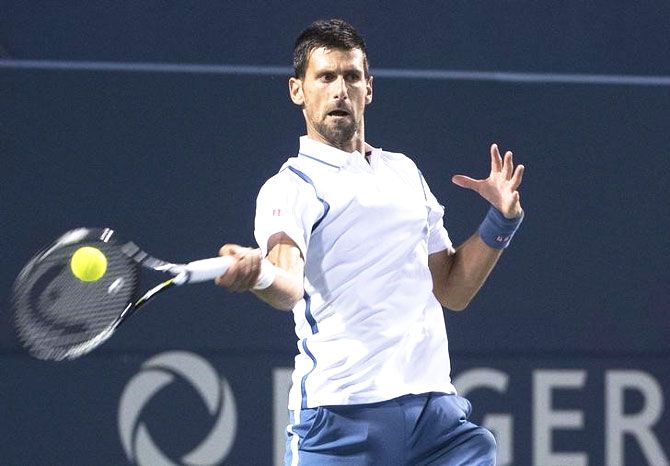 Novak Djokovic returns a ball during his semi-final against Gael Monfils at the Rogers Cup tennis tournament at Aviva Centre