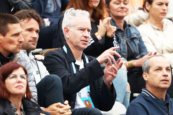 John McEnroe watches the action during the fourth round match between Milos Raonic of Canada and Alberto Ramos Vinolas of Spain at the 2016 French Open on May 29