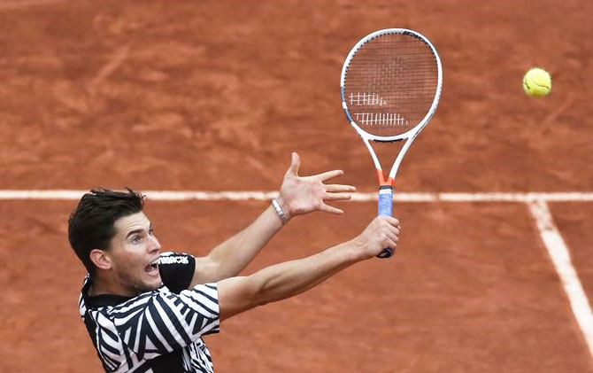 Austria's Dominic Thiem plays a return against David Goffin during their French Open quarter-final on Thursday